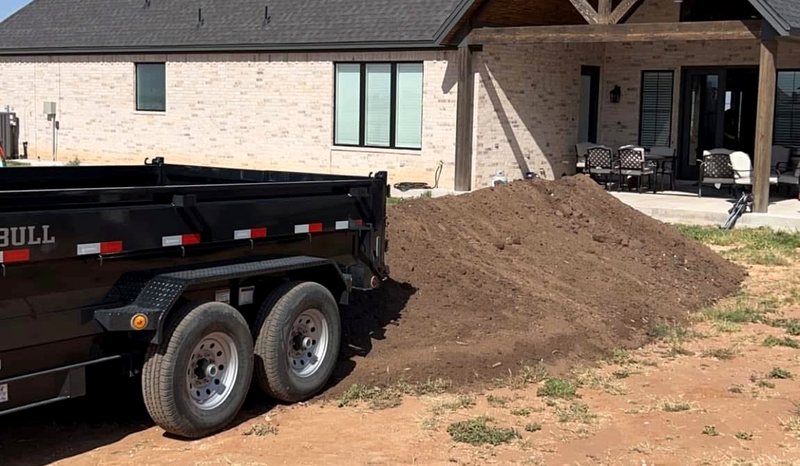 Demolition X dump trailer and material delivery at a Lubbock job site